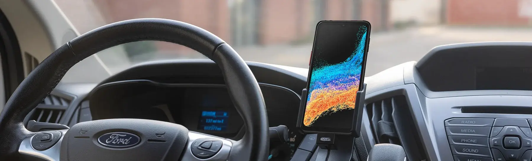 Rugged device mounted in a hardwired in-vehicle charging cradle